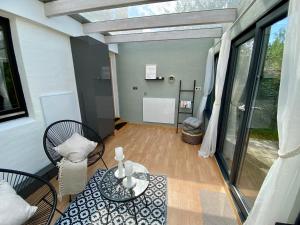 a living room with a glass table and chairs at Haus No. 16 in Ratzeburg