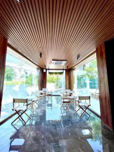 a dining room with tables and chairs in a building at Skeyndor Health & Resort in Na Jomtien