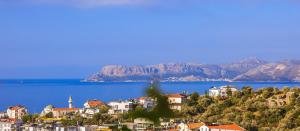 a town on a hill next to a body of water at Aphrodite Hotel Kaş in Kaş