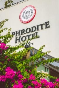 a sign for a phosphate hotel with pink flowers at Aphrodite Hotel Kaş in Kas