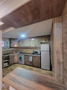 a kitchen with a refrigerator and a washer and dryer at Jacquard Apartment in the centre of Kutaisi in Kutaisi