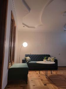 a living room with a couch and a table at Jacquard Apartment in the centre of Kutaisi in Kutaisi