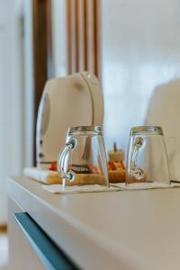 two cups sitting on a counter with a toaster at Vila K2 in Vrdnik