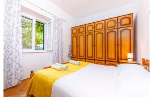 a bedroom with a large bed with a large wooden headboard at Family House Gata in Gata