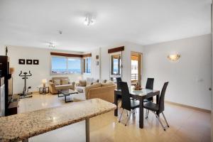 a living room with a table and a dining room at Beautiful Apartament Sol Paraiso BALCONY& SEA POOL in Adeje
