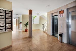 a hallway of a building with a tile floor at Beautiful Apartament Sol Paraiso BALCONY& SEA POOL in Adeje