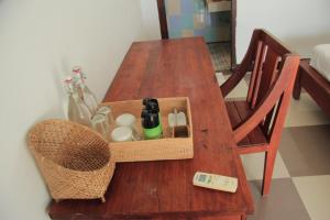 a wooden table with a basket on top of it at Dream CoWork Hotel in Kuta Lombok