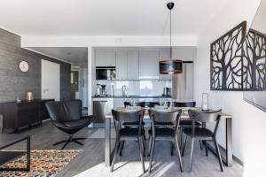 a kitchen and dining room with a table and chairs at Polar Charm huoneistot H ja J in Ylläsjärvi