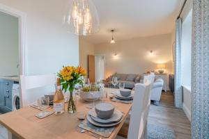 a dining room and living room with a table and chairs at Wallhope Retreat in Chepstow