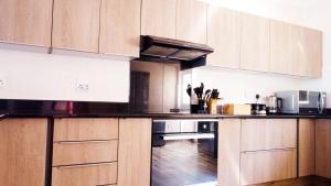 a kitchen with wooden cabinets and a stove top oven at The Donga House - Luxury Home near Scottburgh Beach in Scottburgh