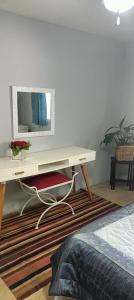 a white desk with a mirror on a wall at Wylie Hall Guesthouse in Durban