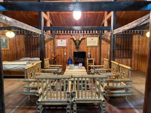 a dining room with tables and chairs in a barn at Hồ Thang Hen in Trà Linh