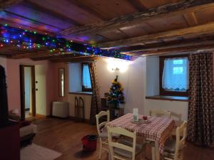 a dining room with a table with a christmas tree on it at Maison 1940 La Bethaz in Valgrisenche