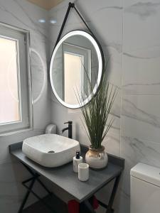 a bathroom with a sink and a mirror at Sea Holly Gozo in Nadur