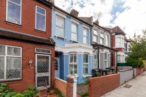 a row of colourful houses in a street at The Finsbury Park Collection in London