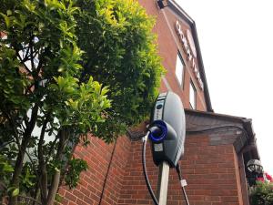 a security camera attached to the side of a brick building at The Dolby Hotel Liverpool - Free city centre parking in Liverpool