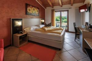 ein Schlafzimmer mit einem Bett in einem Zimmer mit einem Balkon in der Unterkunft Agriturismo San Maggiore in Malcesine
