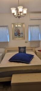 a bedroom with a large bed with a blue pillow at Villa Karla B&B in Veli Iž