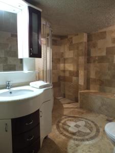 łazienka z umywalką, toaletą i wanną w obiekcie Anatolia cave hotel Pension w Göreme