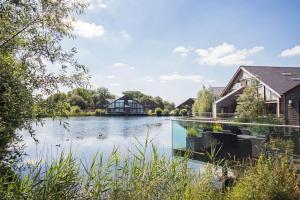a view of a lake with houses in the background at Waters Edge 05, Amaranth Lodge - P in South Cerney