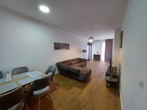 a living room with a couch and a table at Soho City 708B in Bar