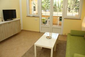 a living room with a couch and a coffee table at Apartments Jadera in Privlaka