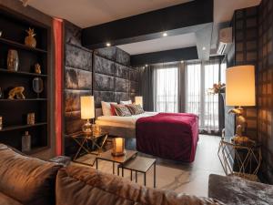 a hotel room with a bed and a couch at Art Suites Boutique Hotel - Krakow Center in Krakow