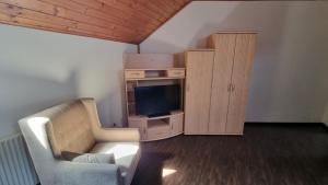 a living room with a couch and a tv and a cabinet at Villa Theresa Apartments 