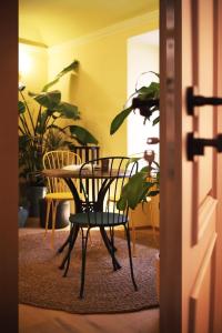 a table and chairs in a room with plants at 7oaks Noble House in Dubrovnik