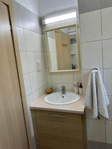 a bathroom with a sink and a mirror at Sidra's Apartment in Paralimni +32 photos