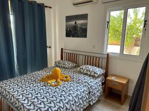 a bedroom with a bed with a teddy bear on it at Sidra's Apartment in Paralimni