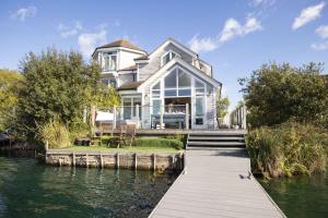 a large house on the water with a dock at The Landings 18, Waters Reach - P in South Cerney