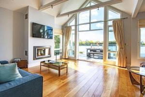 a living room with a blue couch and a fireplace at The Landings 18, Waters Reach - P in South Cerney