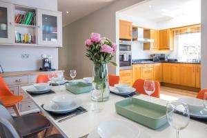 a kitchen with a table with a vase of flowers at The Landings 18, Waters Reach - P in South Cerney