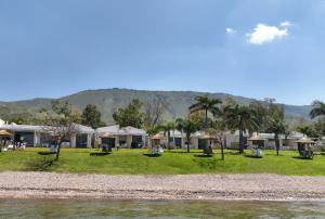 a resort with palm trees and a body of water at Ein Gev Holiday Resort in Ein Gev