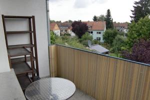 a balcony with a table and a view of a city at Ferienwohnung Bad Vilbel in Bad Vilbel