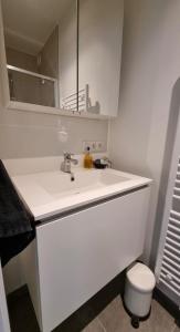 a white bathroom with a sink and a toilet at Luxe 4p appartement aan jachthaven van Zeebrugge Met terrassen en gratis parkeren in Zeebrugge +31 photos