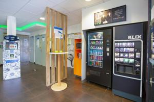 a store with a vending machine and a drink cooler at Ibis Budget Grenoble Sud Seyssins in Seyssins