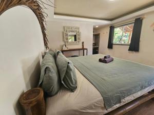 a bedroom with a large bed with pillows at The Mellow Mango in Ko Lanta