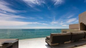 a view of the ocean from the balcony of a house at Palais Rhoul & Spa Dakhla in Dakhla