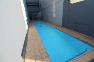 a swimming pool with blue water in a building at Boulevard 4 in Margate