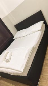 a bed with white sheets and pillows on it at Aparthotel Residence in Vienna