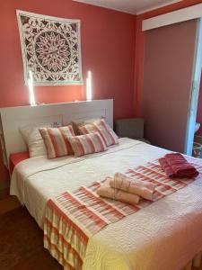 a bedroom with a large bed with red walls at Annette's Home in Mazingarbe
