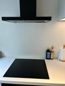 a kitchen counter with a black counter top at Ghent by the water in Ghent