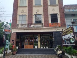 a building with a hotel entrance with stairs in front at Hotel Luxurio by Shree Hari Hotels in Amritsar