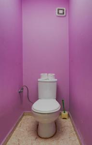 a bathroom with a toilet in a purple wall at The Right Choice 1 in Sofia