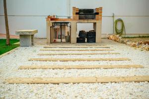 un patio de piedra con mesa y banco en Madera y Miel Casa Rural con niños en Puy du Fou, en Guadamur