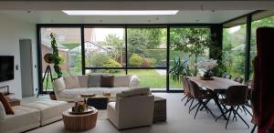 a living room with a couch and a table at Privé kamer met eigen douche en lavabo in Bruges