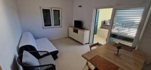 a living room with a couch and a table at Sunset Apartment in Sevid +27 photos