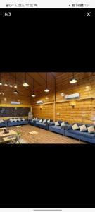 a large room with blue chairs and tables and lights at القصر الريفي in Khafji +44 photos